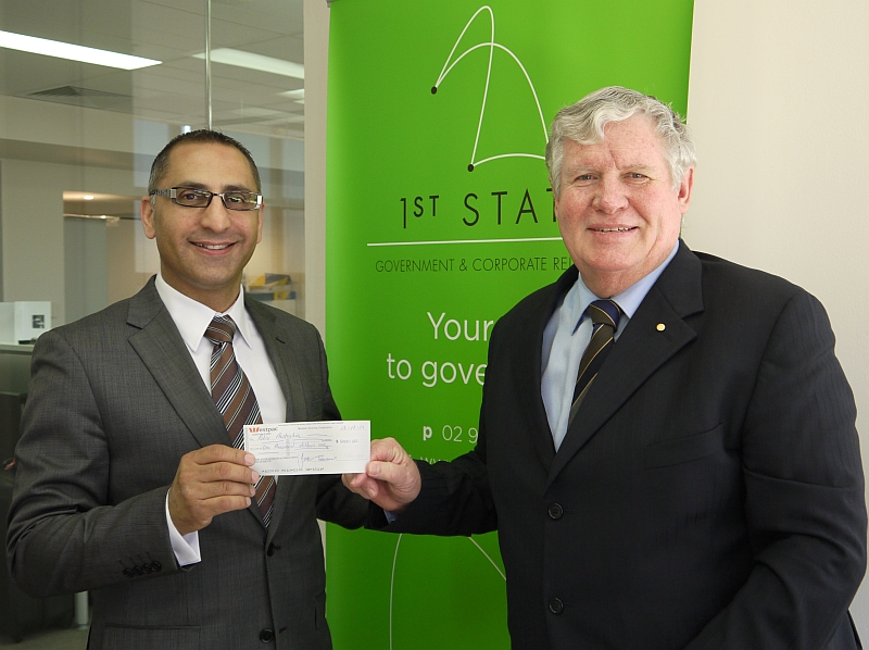 Joseph Tannous, founder of 1st State Government and Corporate Relations, hands a donation cheque to Dr John Tierney OAM, Special Counsel at 1st State Government and Corporate Relations, and National Patron of Polio Australia