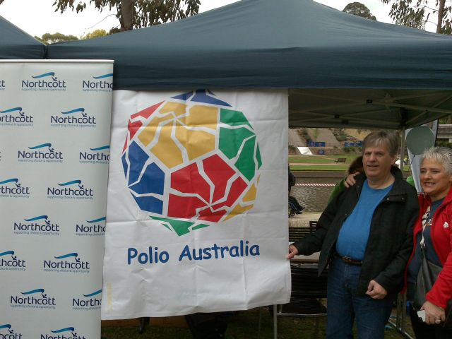 Polio Australia's registration table, with Walk team members Michael and Lisa looking on